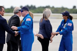 NASA astronauts Butch Wilmore and Suni Williams greet NASA and Boeing officials after landing following a flight over the launch pad, ahead of the launch of Boeing's Starliner-1 Crew Flight Test (CFT), in Cape Canaveral, Florida, U.S., April 25, 2024. REUTERS/Joe Skipper