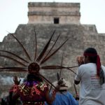 FILE PHOTO: A group of people wearing pre-Hispanic costumes perform a ritual near the pyramid of Kukulkan at the archaeological zone of Chichen Itza in Yucatan State, December 21, 2012. REUTERS